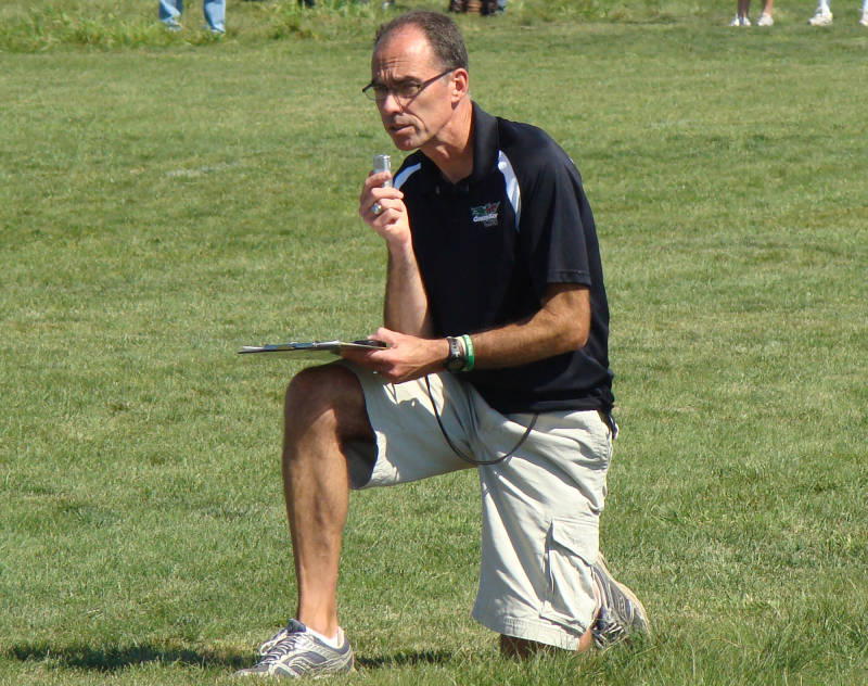 Coach Mike Kline taking notes during a meet.