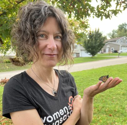 woman holding a brand new monarch butterfly